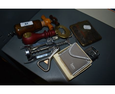 A collection of vintage cork screws,a Ronson lighter in box and a a cigarette case.