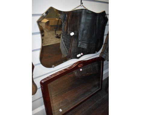 A vintage bevelled glass mirror having scalloped edge.