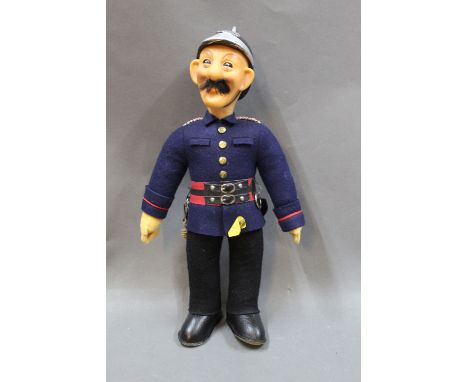 A Steiff fire fighter, Fireman Ziegler, having button and tag, measuring 32cm high
