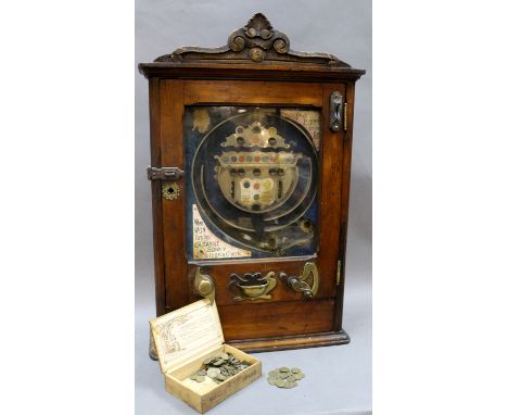 A Victorian mahogany penny slot machine, manufactured by Monarch, Reg. No. 574253, the case measuring 88cm tall. Provenance -