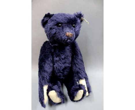 A Steiff 1909 replica teddy bear, 406508, having a dark blue mohair covered body, light beige felt paws, button, tag &amp; wo