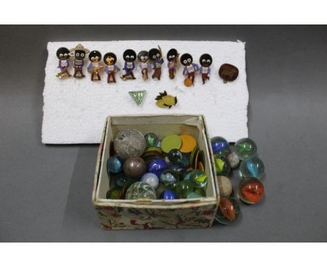 A small group of enamelled badges, to include a Corgi Model Club badge, together with a collection of marbles