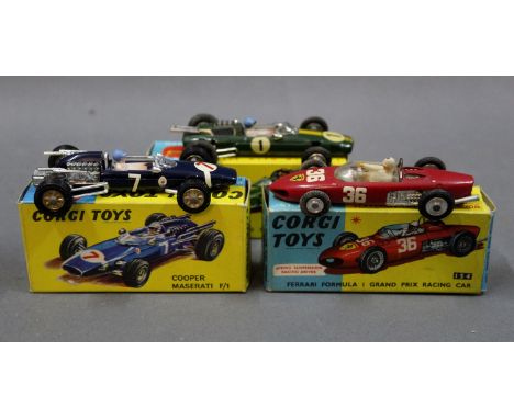 A group of three Corgi diecast model racing cars : A Ferrari Formula 1 Grand Prix racing car (154), A Coupe Maserati F/1 (156