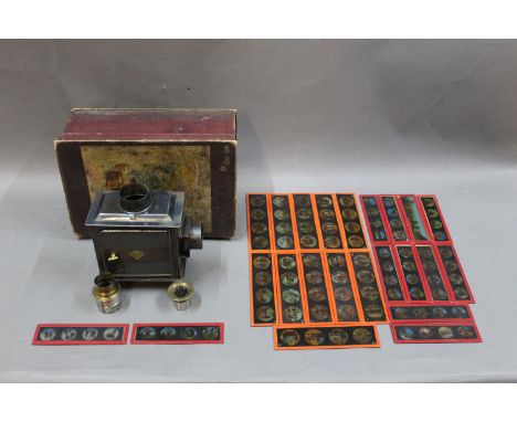 An early 20th century Gerbrude Bing magic lantern projector with eleven slides