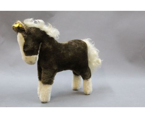 A 1960's/70's Steiff horse, having button and tag to its ear, measuring 25cm tall