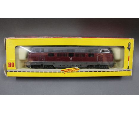 A Fleischmann HO scale DB class 221 diesel locomotive in maroon livery, displayed within a 1381 box 