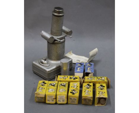 A 1950's miniature projector with 10 boxed Johnson Disney film strips to include Mickey Mouse