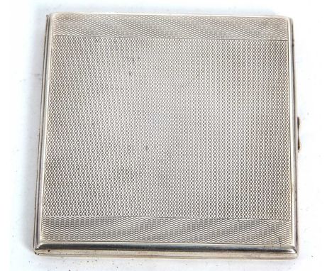 An Art Deco silver cigarette case of rectangular form having all over engine turned decoration, push in clasp with a full len