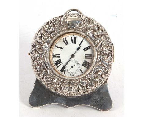 An Edwardian silver cased Goliath watch with  silver mount and leather easel back, the front circular mount embossed with flo