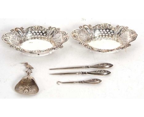 Mixed Lot: A pair of silver pierced and embossed bonbon dishes, Sheffield 1913, 12.5 x 8.5cm, a Dutch white metal caddy spoon