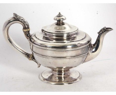 A Victorian silver teapot of plain circular form with reeded bands, leaf capped handle and spout, supported on a stepped spre