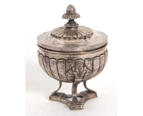 An antique continental white metal caddy of urn form, the pull-off cover with raised fluted decoration and a pineapple finial