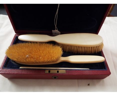 An early 20thC cased ivory brush and comb set 