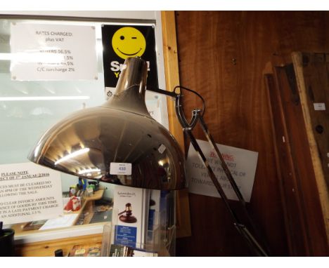 A large floor standing chrome anglepoise lamp