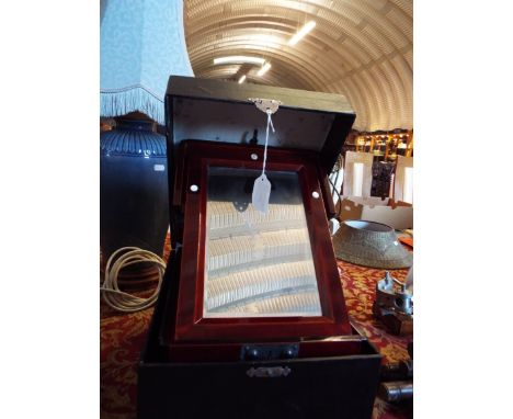 A boxed Oriental mother of pearl inlaid lacquered vanity box the folding mirrored top above a single drawer and raised on bra
