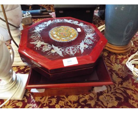 An Oriental teak jewellery box with damask lined interior, an Oriental red lacquered octagonal box with mother of pearl inlai