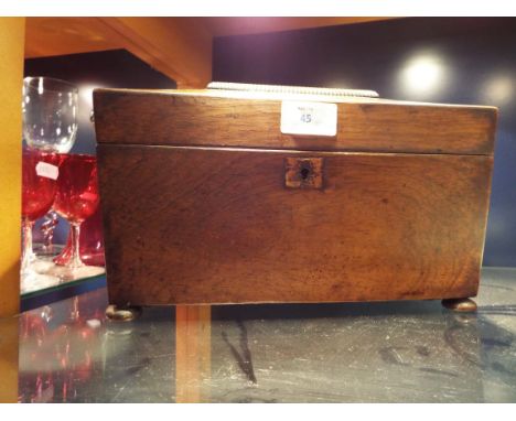 A Regency rosewood sarcophagus tea-caddy resting on bun feet 
