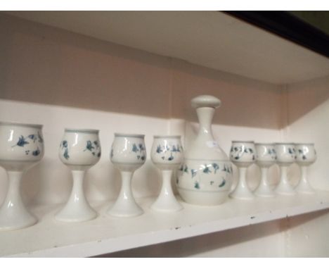 An Iden Pottery decanter and eight goblets having blue ivy decoration