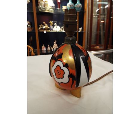 A French 'Cenem' Art Deco ceramic lamp of ovoid form with floral decoration resting on triform base     restoration to top la