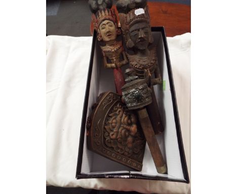 Two carved hand-painted Thai wall hangings, a carved pumice stone, a Chinese terracotta plaque with dragon decoration signed 