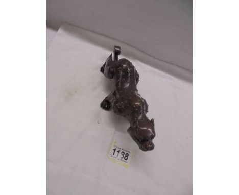 A bronze figure of a stalking leopard.