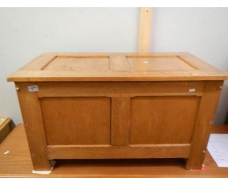 A paneled light oak blanket box with hinged lid, 53H x 90W x 49D. COLLECT ONLY.