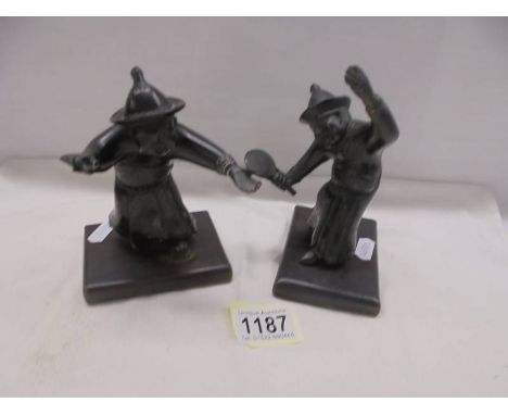 Two bronze Chinese men playing tennis, a/f one figure missing its raquet.