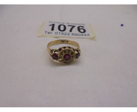 An 18ct gold rings set diamonds and possibly rubies, size M, 2.46 grams.