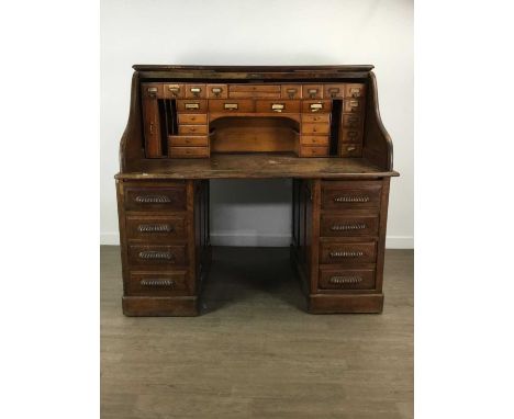 OAK ROLL TOP PEDESTAL DESK, EARLY 20TH CENTURY the tambour front enclosing an arrangement of drawers and pigeon holes, each p