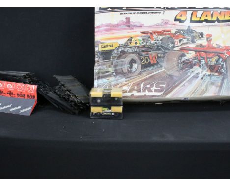 Boxed Scalextric 4 Lane set, together with a quantity of track including curves and straights and cased slot cars to include 