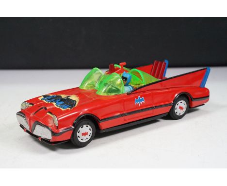 Mid 20th C tin plate Batmobile model in red, complete with both Batman &amp; Robin figures/heads, in a gd play worn condition