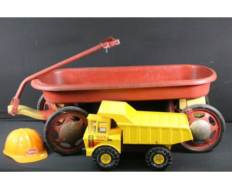 Pull along cart in red, along with yellow Tonka Dumper Truck and Tonka hard hat