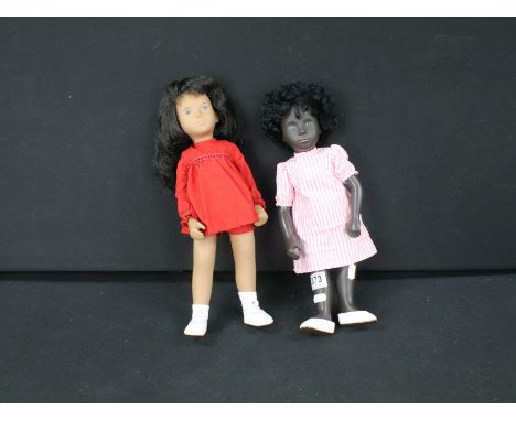 Two Sasha dolls to include boxed 104 Sasha Brunette Red Dress, complete with booklets and unboxed Sasha Black Baby Doll in pi