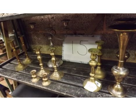 SHELF OF BRASS CANDLESTICK AND A PAIR OF ORIENTAL BRASS VASES