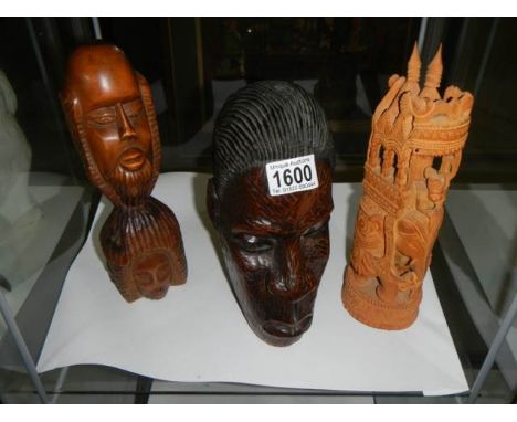 Two native carved wood heads and one other item.