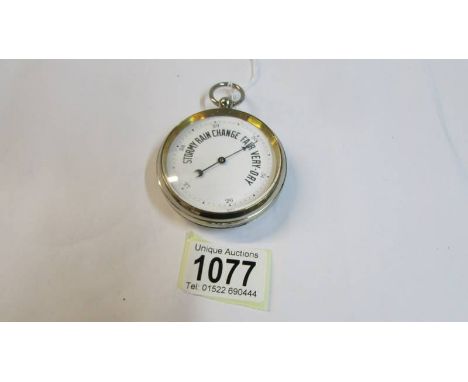 An early 20th century pocket barometer with enamel face.