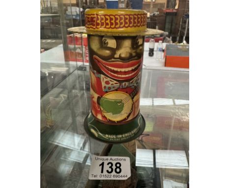 A vintage Minstrel money box tin with spring loaded legs Patent No 680237