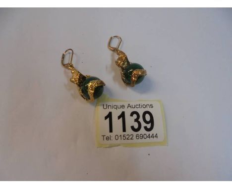 A good pair of gilt and jade earrings.