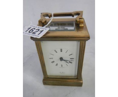 A St. James brass carriage clock in working order (slight crack in rear door).