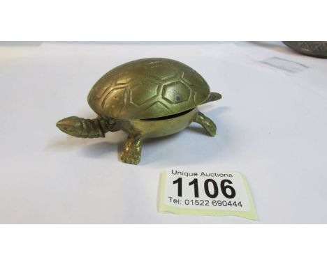 A vintage brass shop counter clockwork bell in the form of a tortoise.
