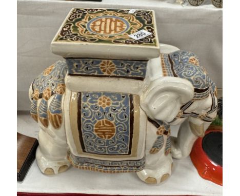 A large ceramic elephant stool/plant stand