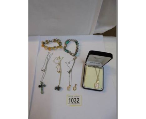 A crystal pendant on silver chain, two jade pendants, 2 other pendants and 2 bracelets.