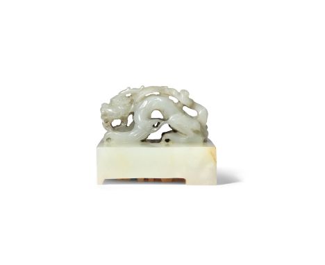 A CHINESE WHITE JADE SQUARE SEAL PROBABLY YUAN DYNASTY The plain base surmounted by a dragon, the mythical beast crouching as