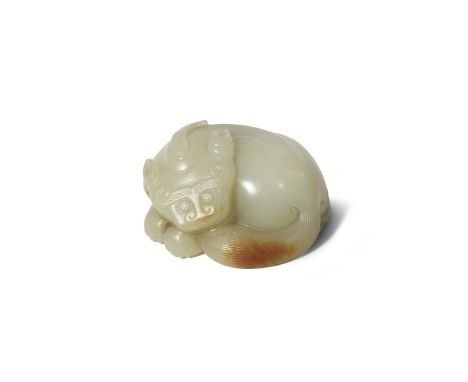 A CHINESE PALE CELADON JADE CARVING OF A RECUMBENT BIXIE QING DYNASTY Its body curled, resting his head upon his paws and tai