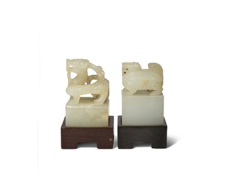 TWO CHINESE PALE CELADON JADE SEALS PROBABLY LATE MING DYNASTY Each carved with a mythical beast stood upon a simple square-s