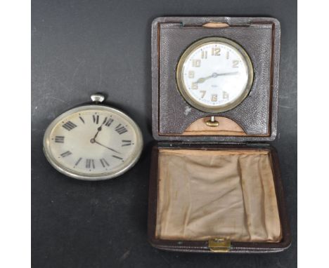 An early 20th century circa. 1930s car clock of oval form with roman numeral to the chapter ring and the pocket watch movemen
