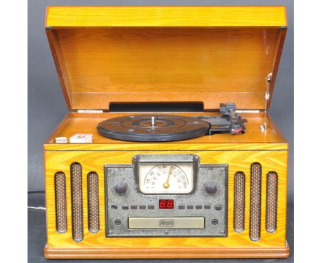 A vintage style combined vinyl record player, CD player, cassette player and radio. The item having CD player and radio contr