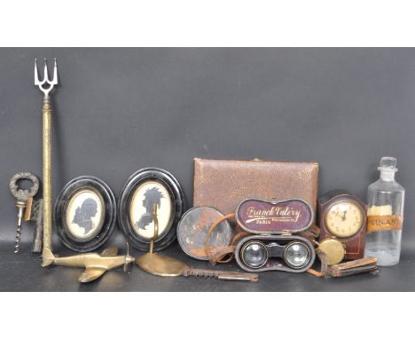 A collection of 19th Century and later curios comprising of a curios bottle, two portrait silhouettes, a glass apothecary bot