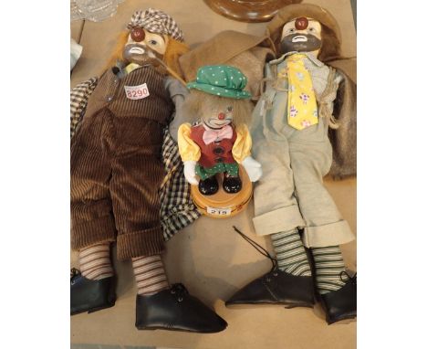 Two ceramic headed clowns and a musical example