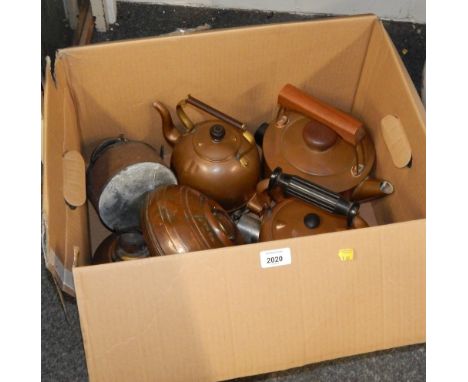 A group of brass and copper wares, three copper kettles, two oil lamp bases, and a Wumup water heater.